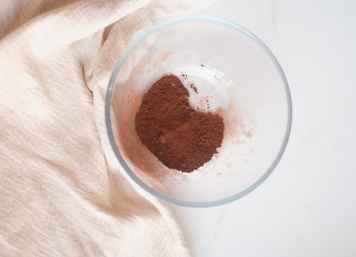 Cacao powder and coconut sugar mixed together in a glass bowl. 