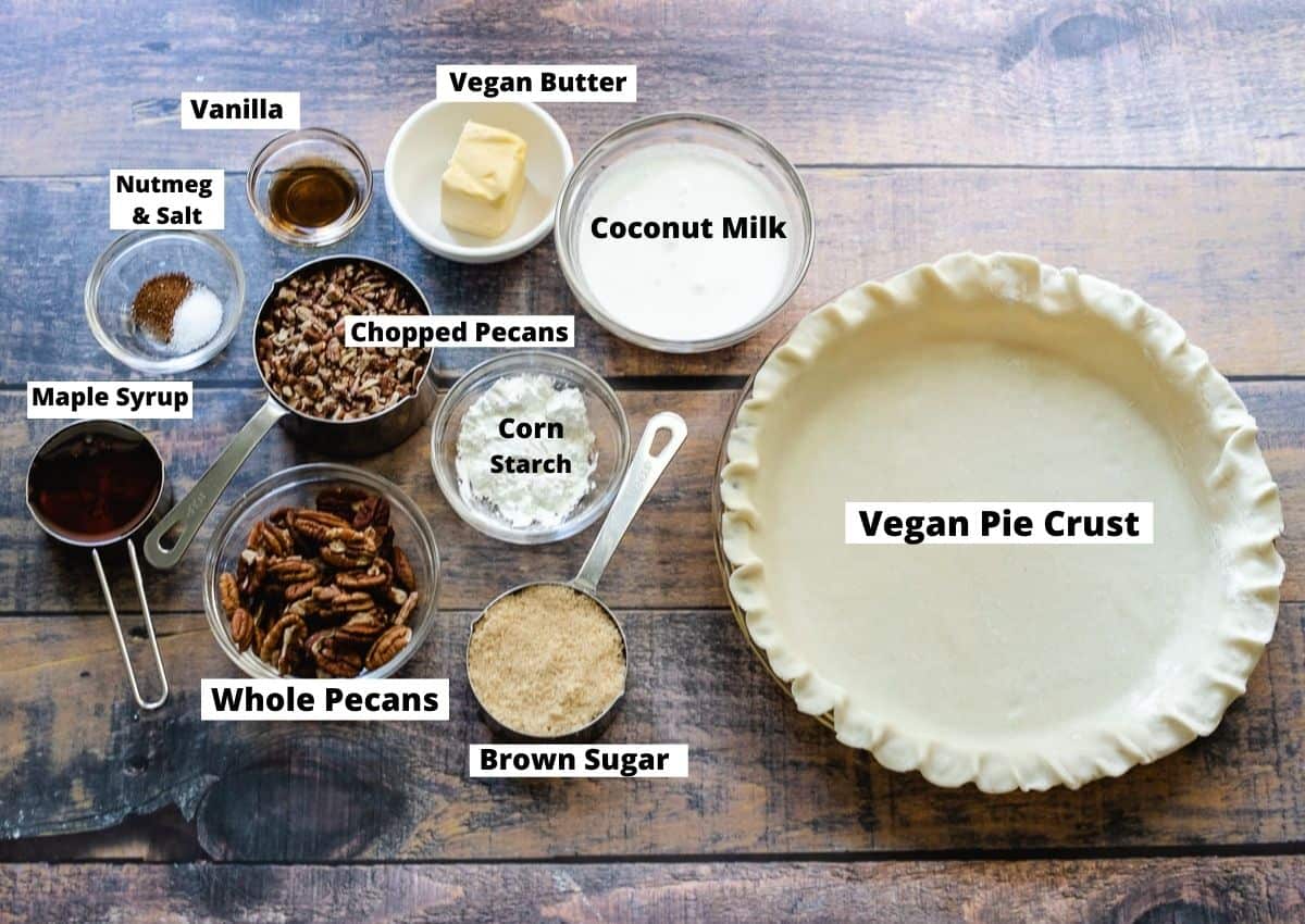 Vegan pecan pie ingredients: pie crust, brown sugar, whole pecans, chopped pecans, corn starch, coconut milk, vegan butter, vanilla, nutmeg and salt, maple syrup.