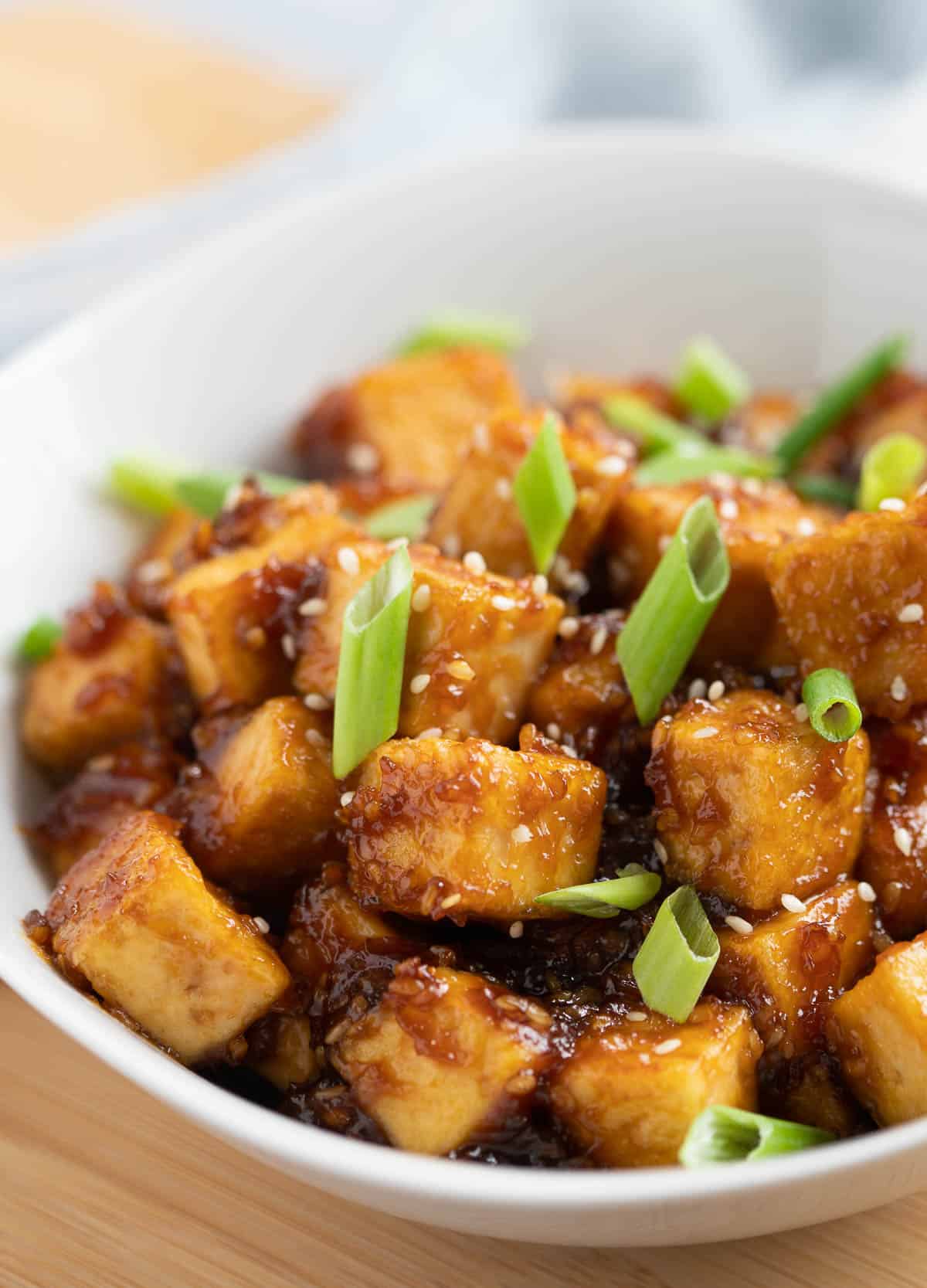 Crispy tofu coated in teriyaki sauce and topped with scallions and sesame seeds.
