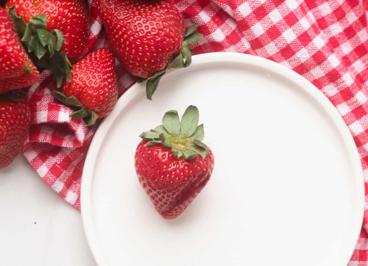 Strawberry on white plate.