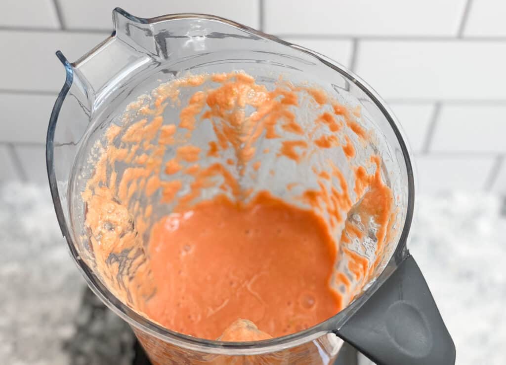 Blended carrot apple smoothie in blender. 
