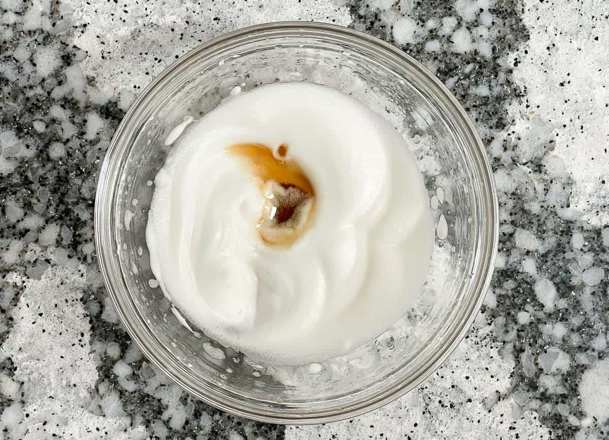Maple syrup added to whipped aquafaba. 
