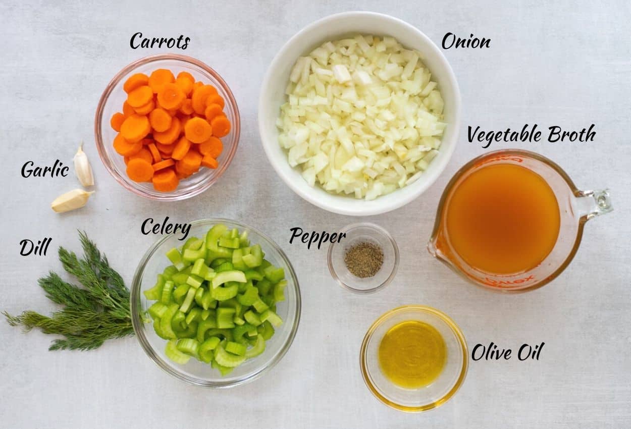 Chopped carrots, diced onion, vegetable broth, olive oil, black pepper, chopped celery, dill, and garlic cloves.
