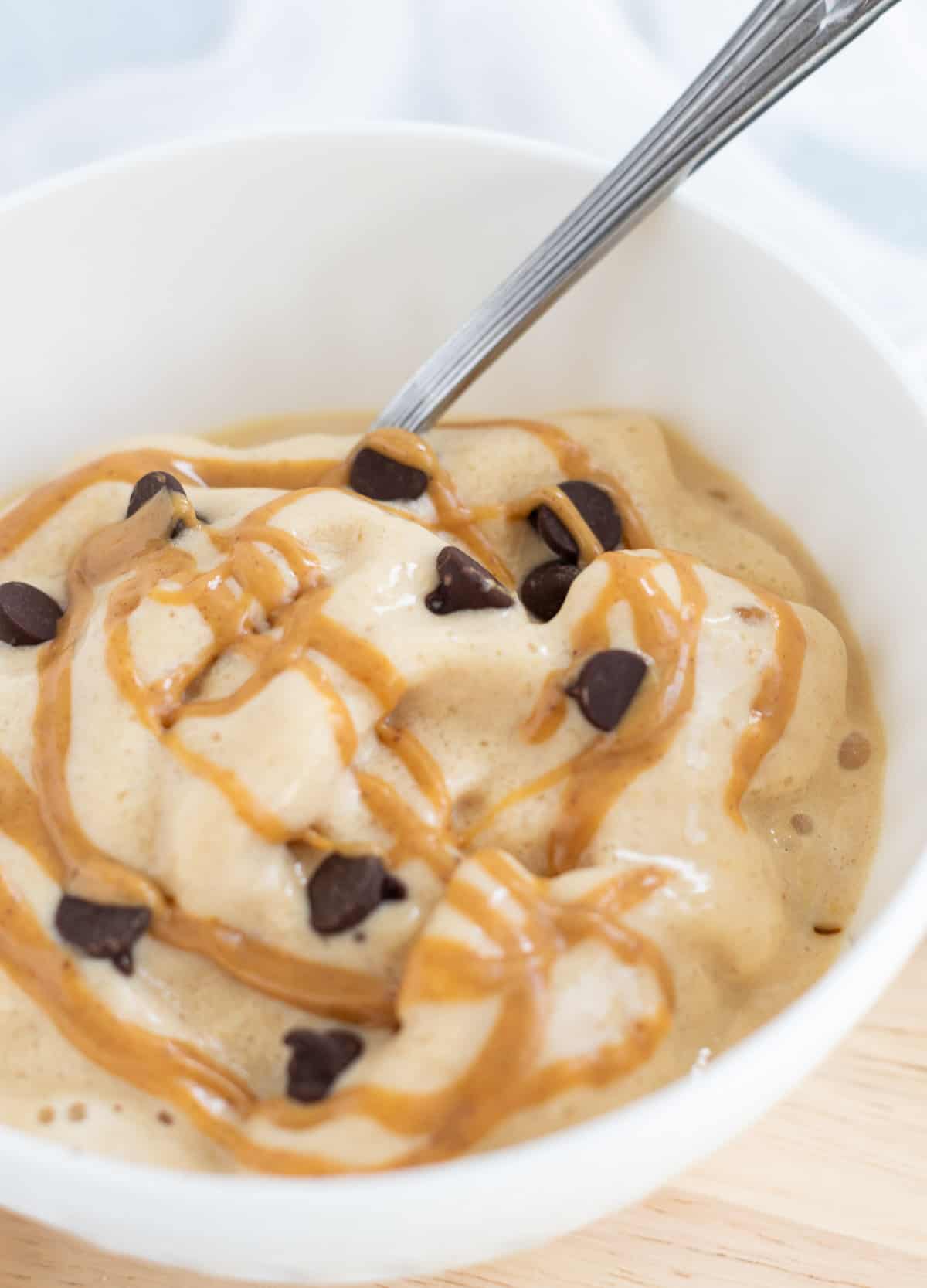 Peanut butter fluff in white bowl topped with chocolate chips. 