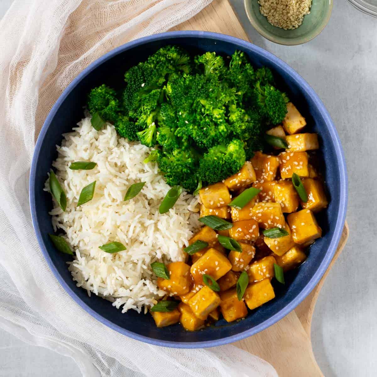 Bowl of orange tofu, broccoli, and rice.