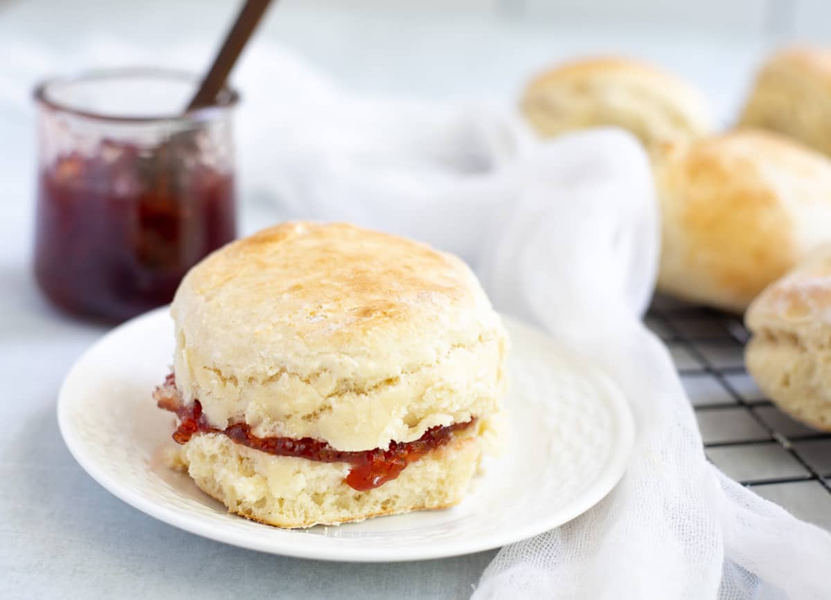 3 ingredient vegan scone filled with jam on white plate. 