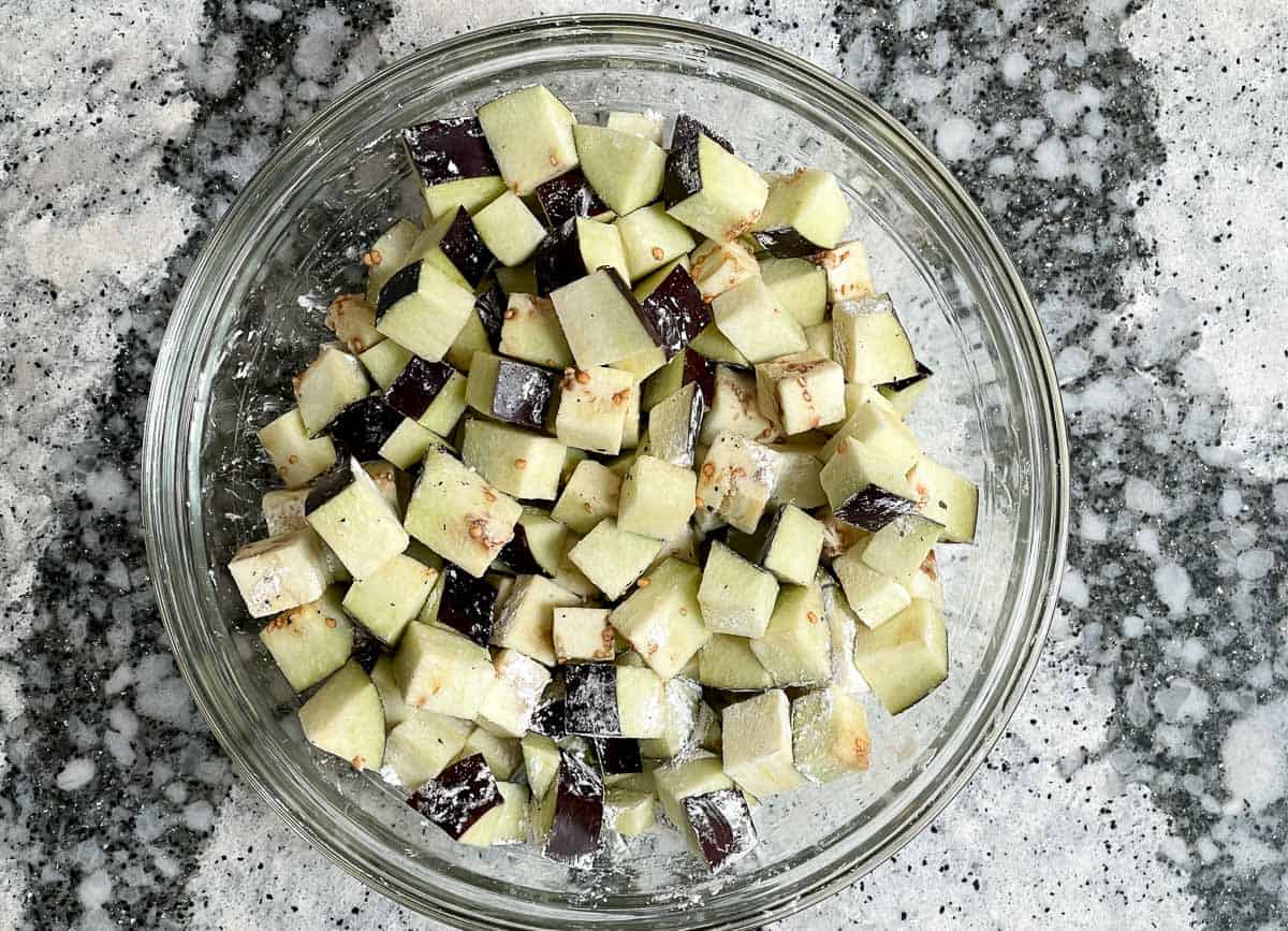 Chopped eggplant cubes tossed with corn starch. 