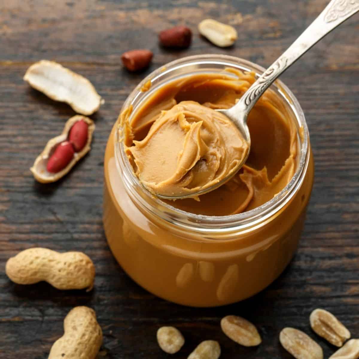 Peanut butter jar with spoon. 
