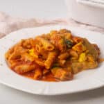 Vegan pasta bake serving on white plate.
