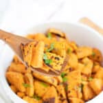 Sweet potato saute on wood spoon.