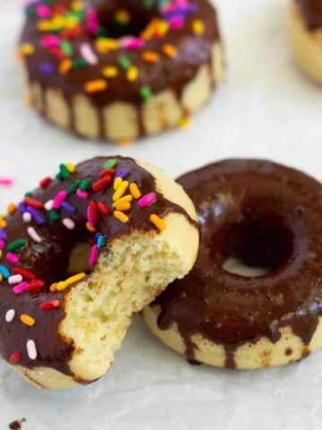 Eggless donuts with vanilla cake and chocolate icing and sprinkles.