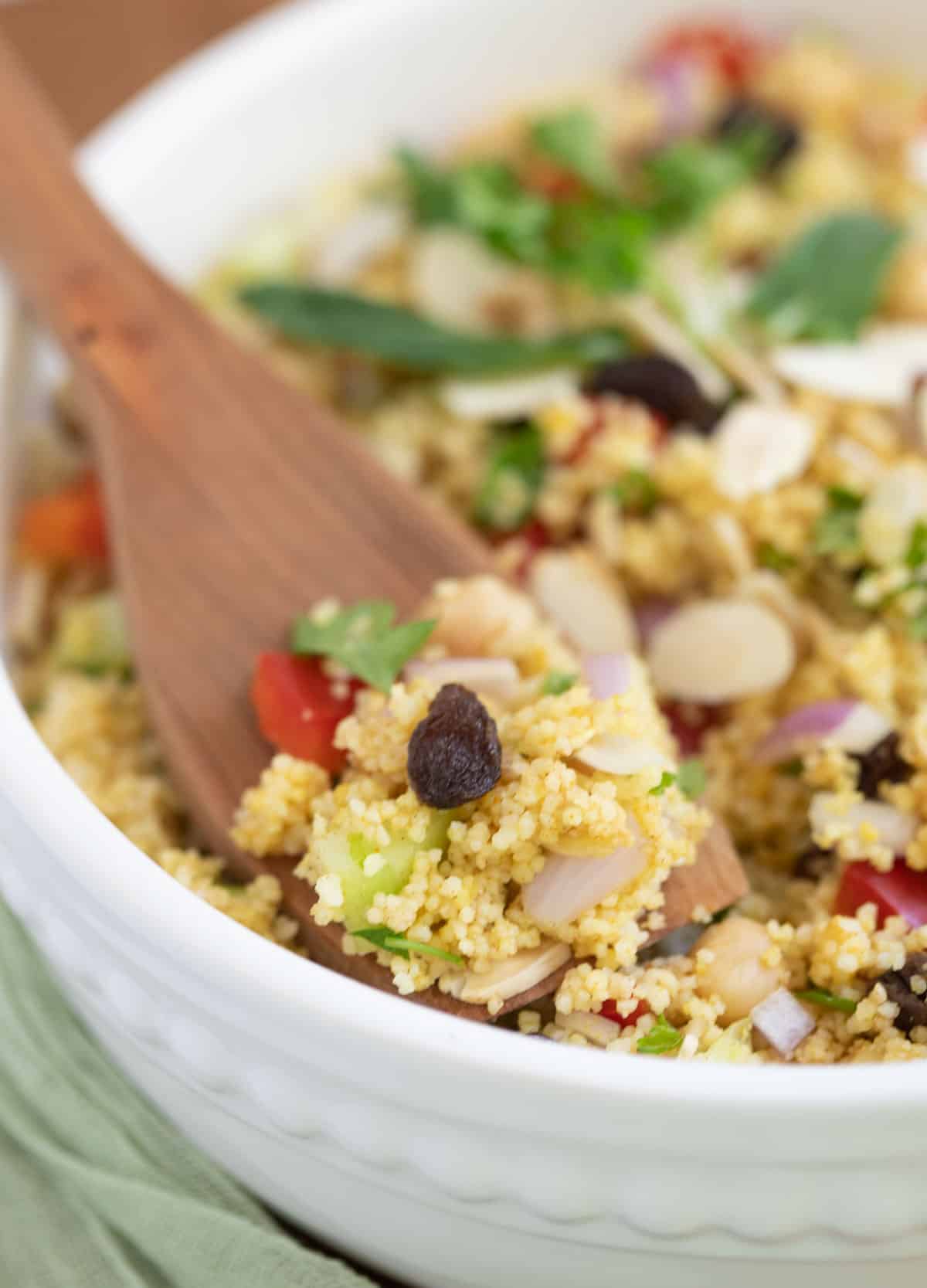 Couscous salad served with spoon.