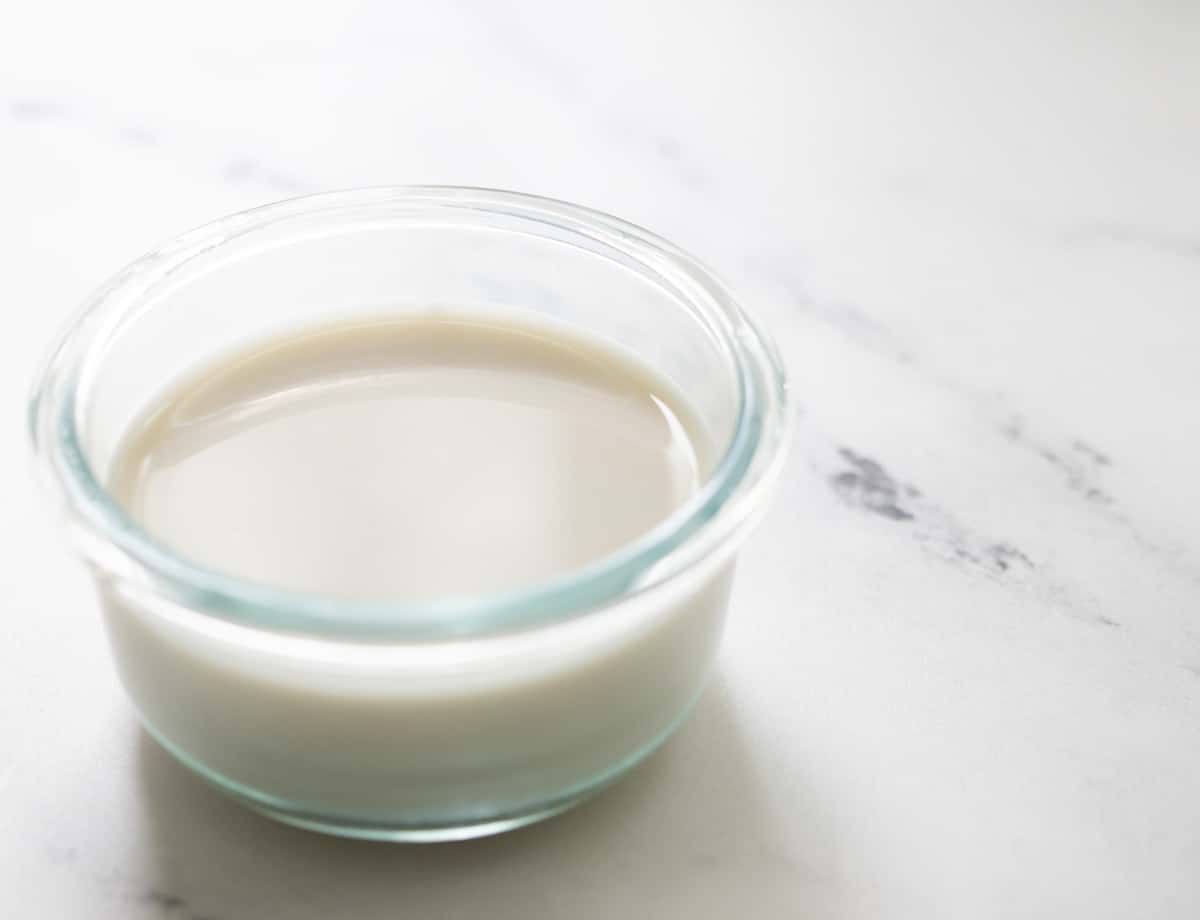 Coconut milk/almond milk in glass container.