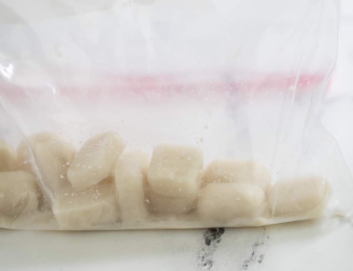 Almond milk ice cubes in plastic bag.