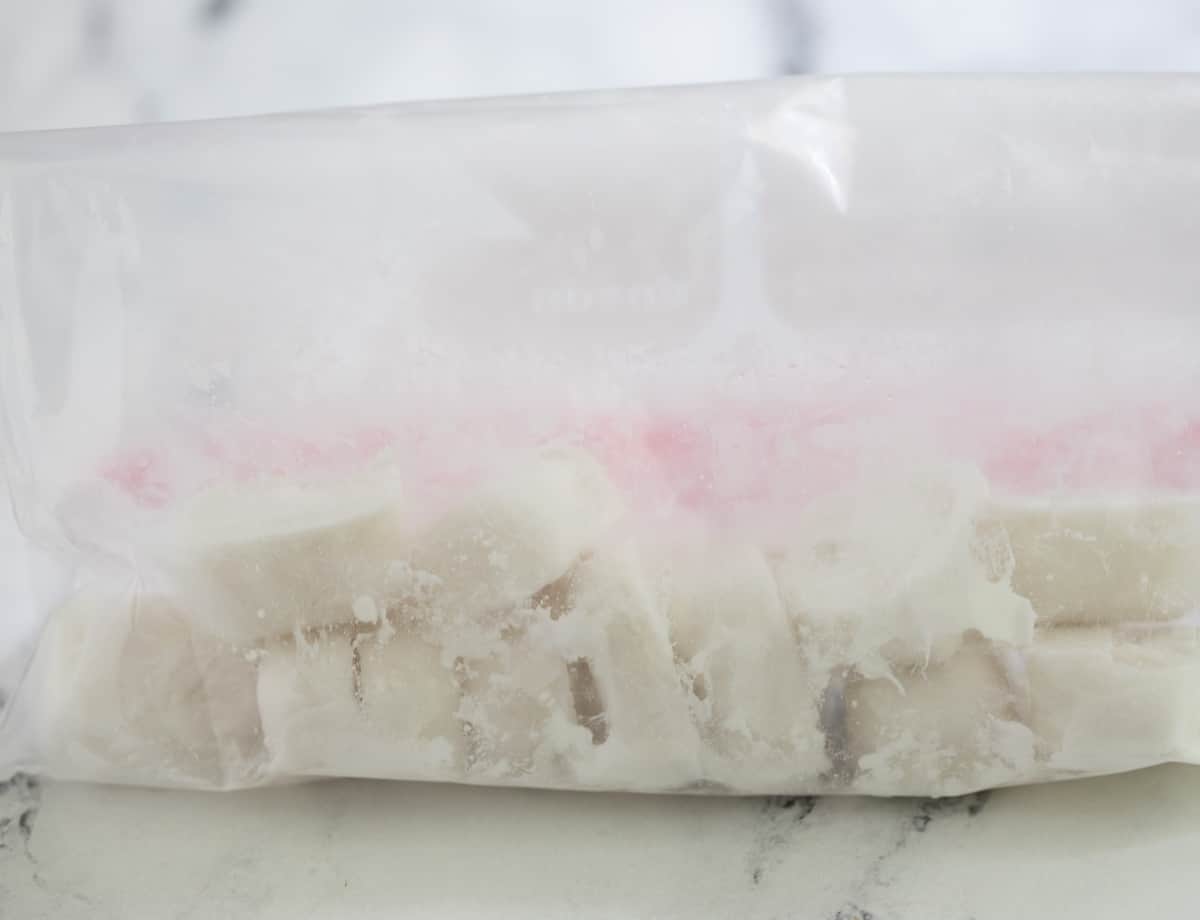 Coconut milk ice cubes in freezer bag.