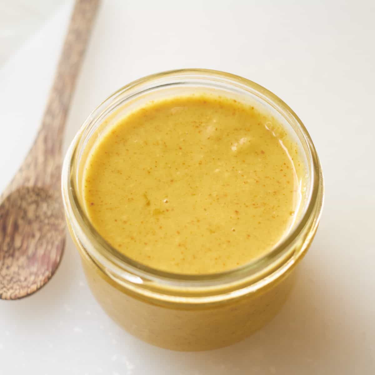 Vegan honey mustard in small jar.