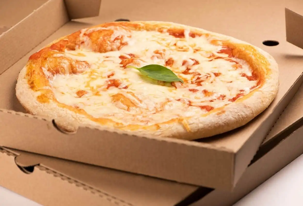 Cheese pizza in cardboard box.