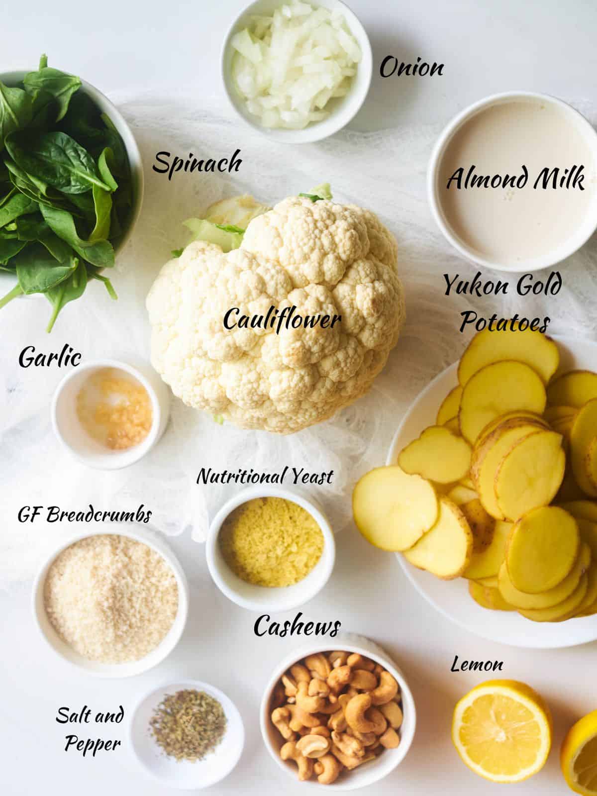 Vegan Potato Casserole Ingredients: spinach, cauliflower, onions, Yukon gold potatoes, breadcrumbs, nutritional yeast, salt and pepper, cashews, lemon