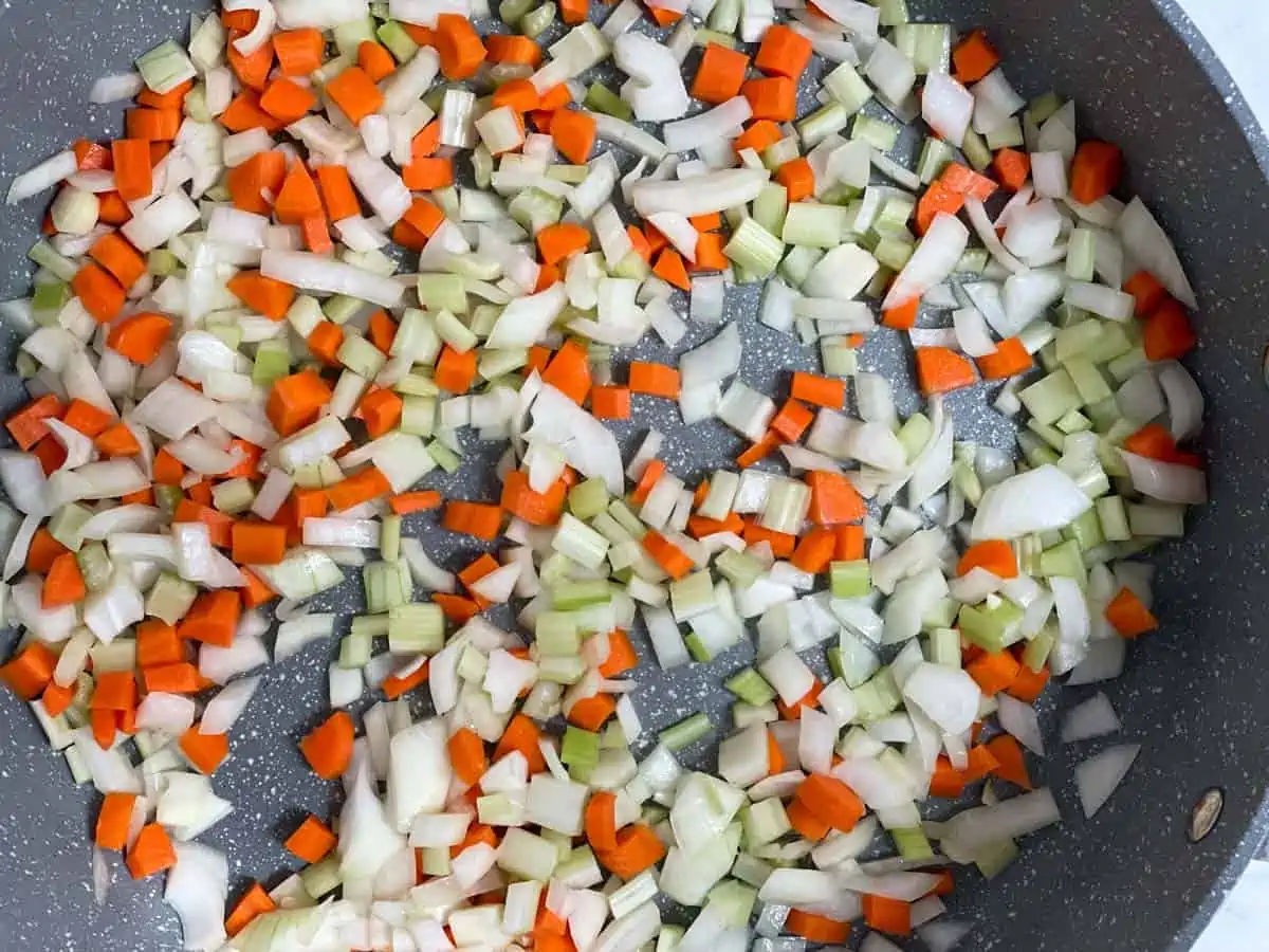 Onions, carrots, and celery in sauté pan. 