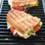 Grilled panini sandwich on grill.