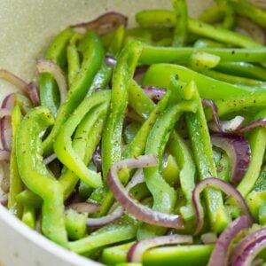 Sauted green peppers and red onion in pan.