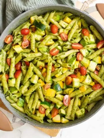 Overhead of pesto veggie pasta in pot.