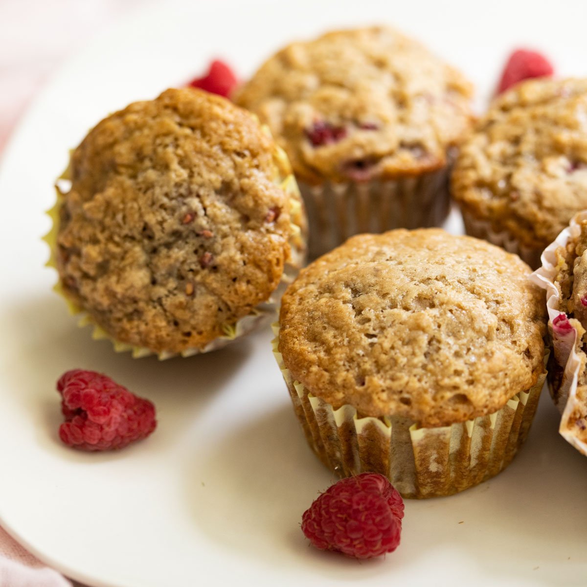 Close up of vegan Raspberry muffins on white plate.
