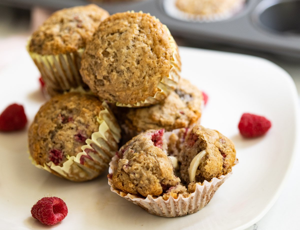 Vegan raspberry muffins on white plate.