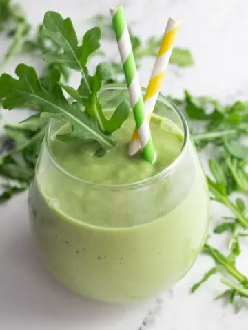 Arugula smoothie in glass.