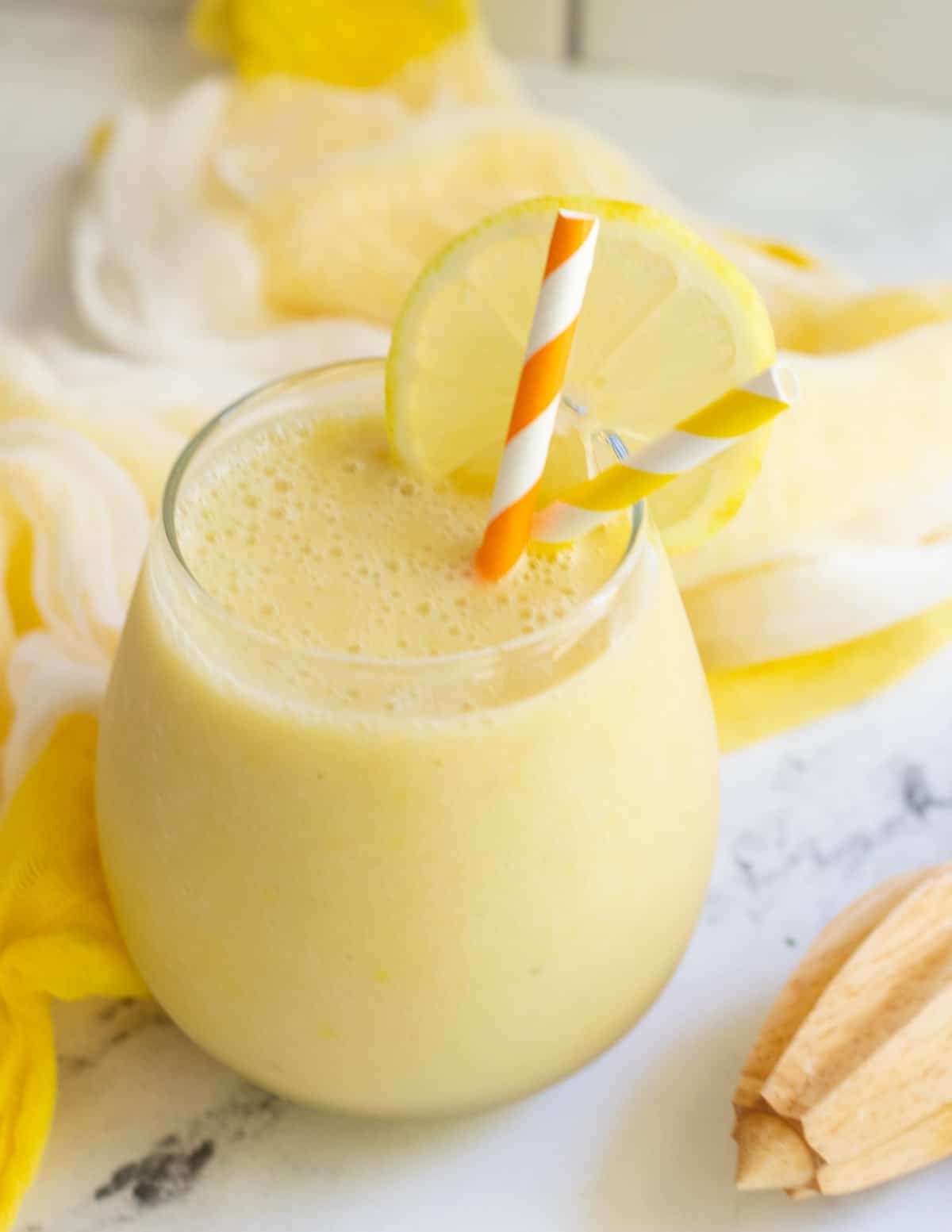 Yellow smoothie in glass.
