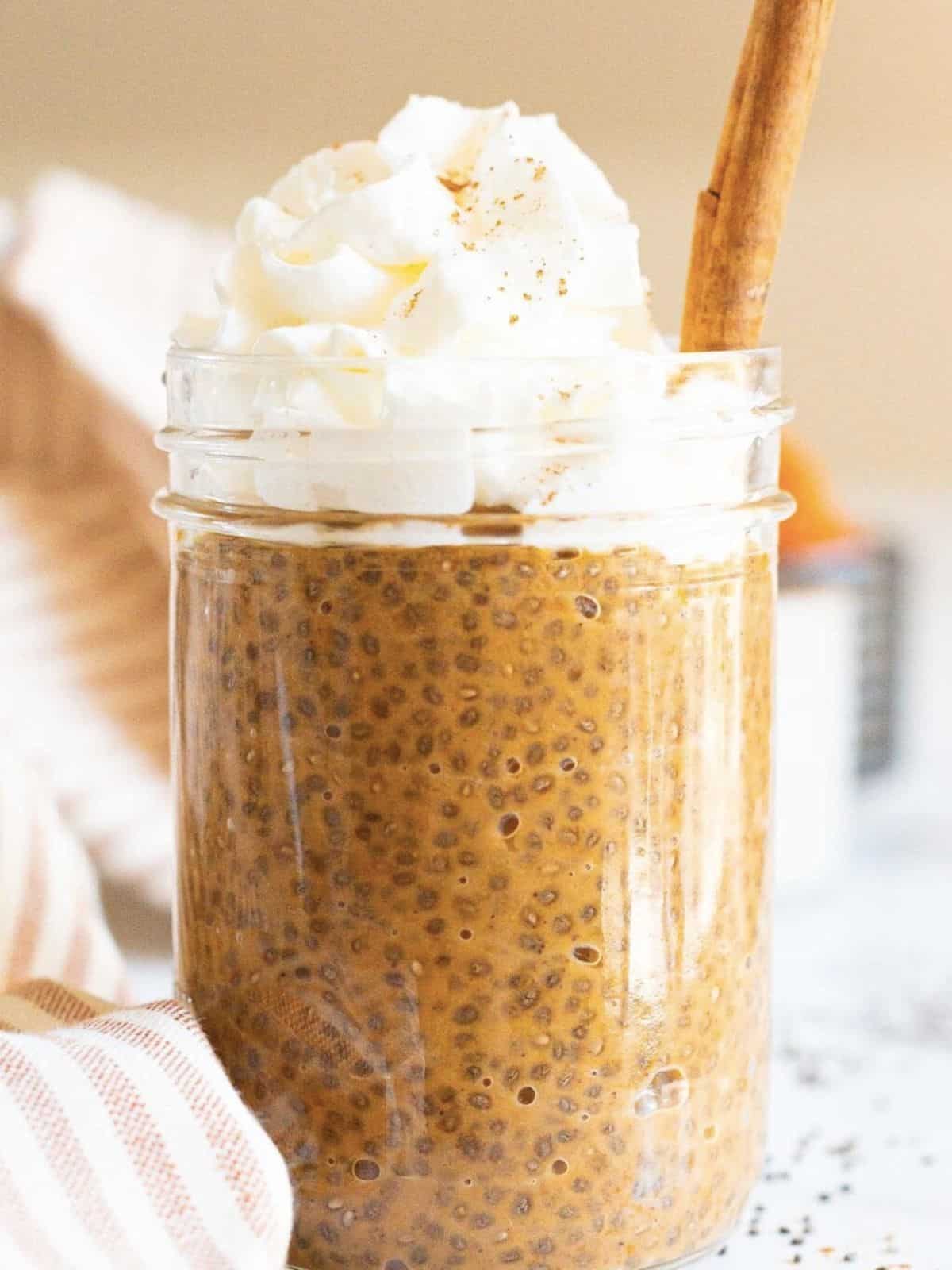 Pumpkin chia pudding topped with whipped cream.