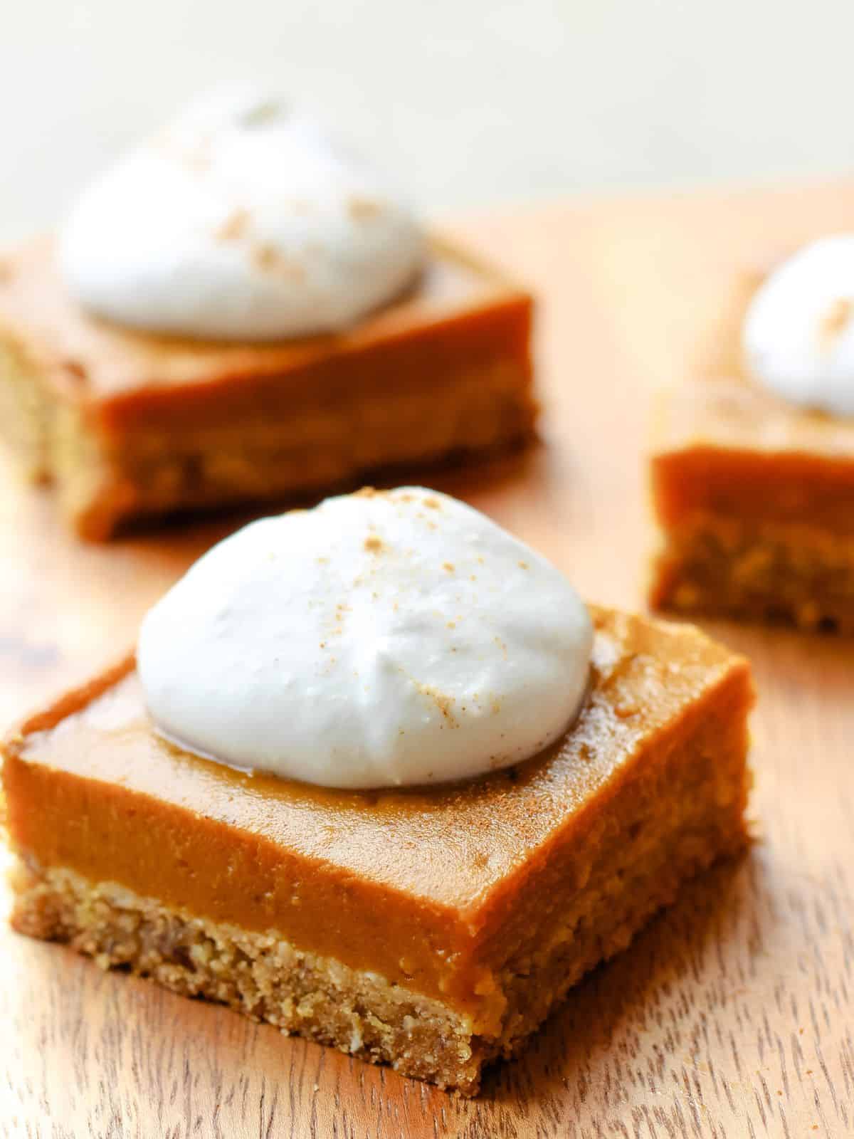 Pumpkin pie bar topped with whipped cream.
