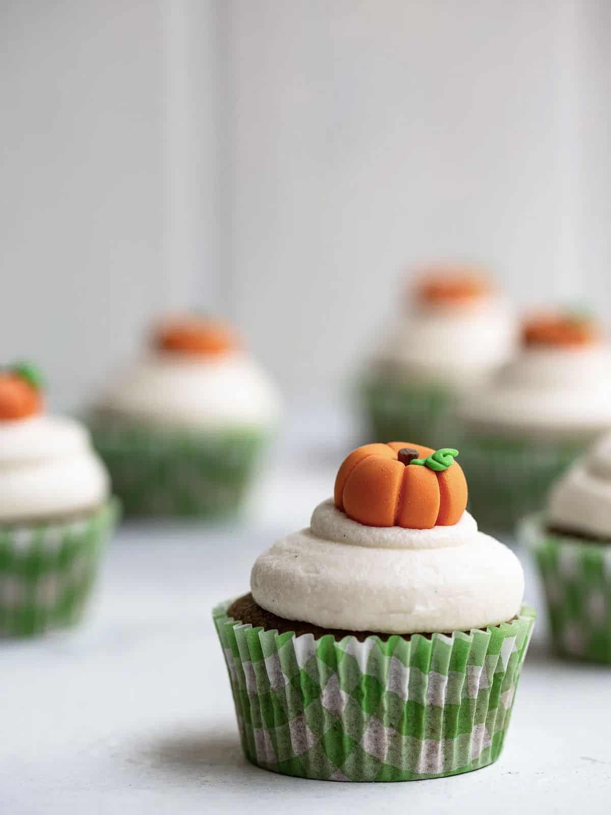 Pumpkin cupcakes topped with candy pumpkin. 