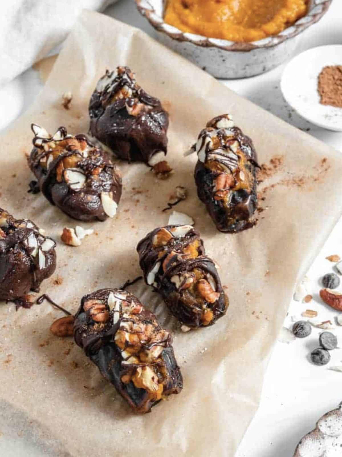 Dates stuffed with pumpkin puree, nuts and drizzled with chocolate. 