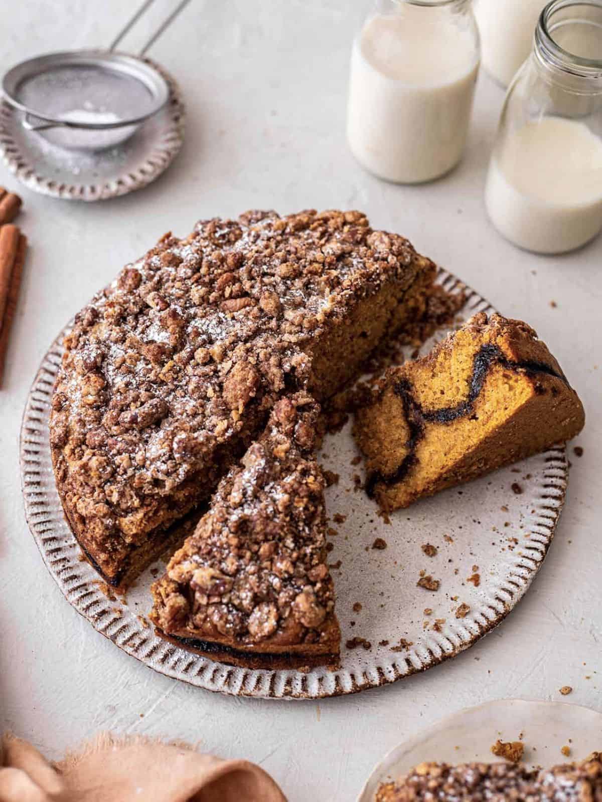Pumpkin coffee cake with slices cut.