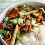 Vegan Stir-fry served with white rice in a white bowl.
