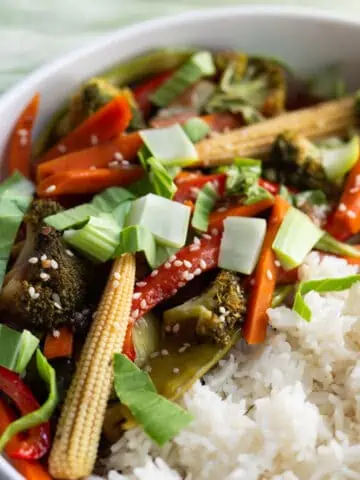 Vegan Stir-fry served with white rice in a white bowl.