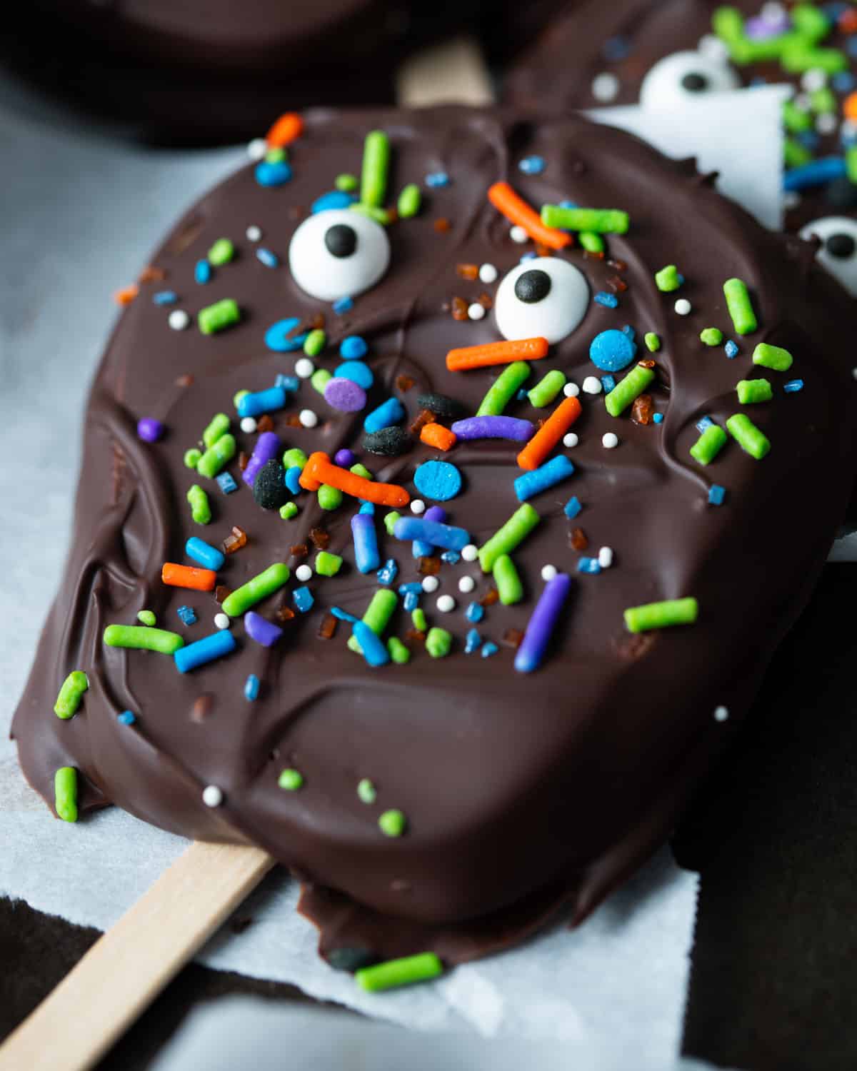 Chocolate covered apple slice with Halloween sprinkles.