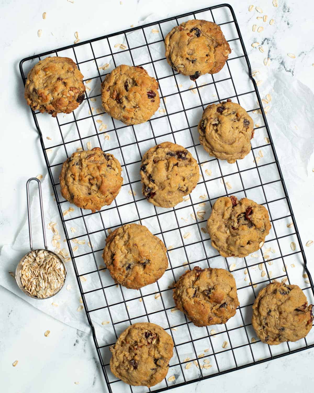 Vegan oatmeal raisin cookies on cooling rack.