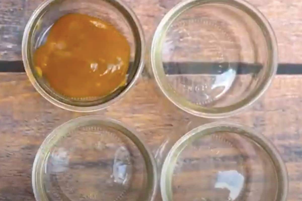 Spooning pumpkin pudding into small jars.
