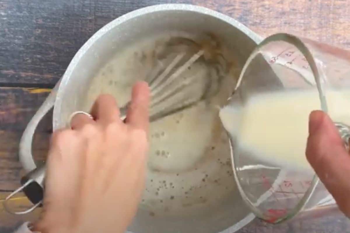 Whisking almond milk into brown sugar and cornstarch.
