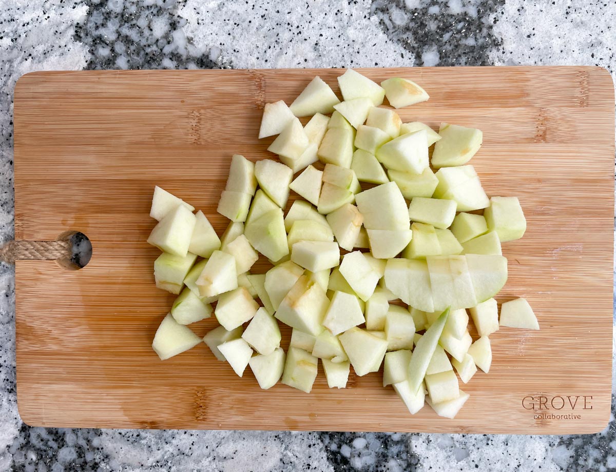 Chopped apples on cutting board.
