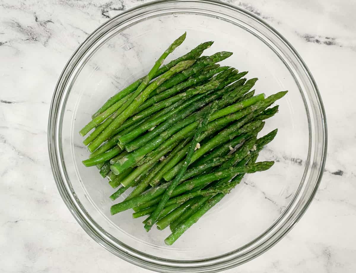 Frozen asparagus in a mixing bowl.
