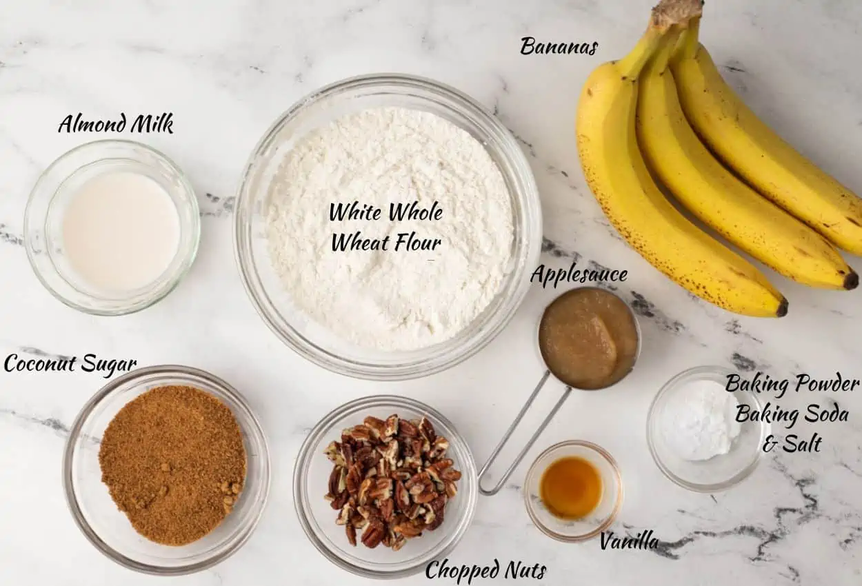Banana Bread Ingredients: bananas, baking powder, baking soda, salt, vanilla, applesauce, chopped nuts, coconut sugar, white whole wheat flour, almond milk.
