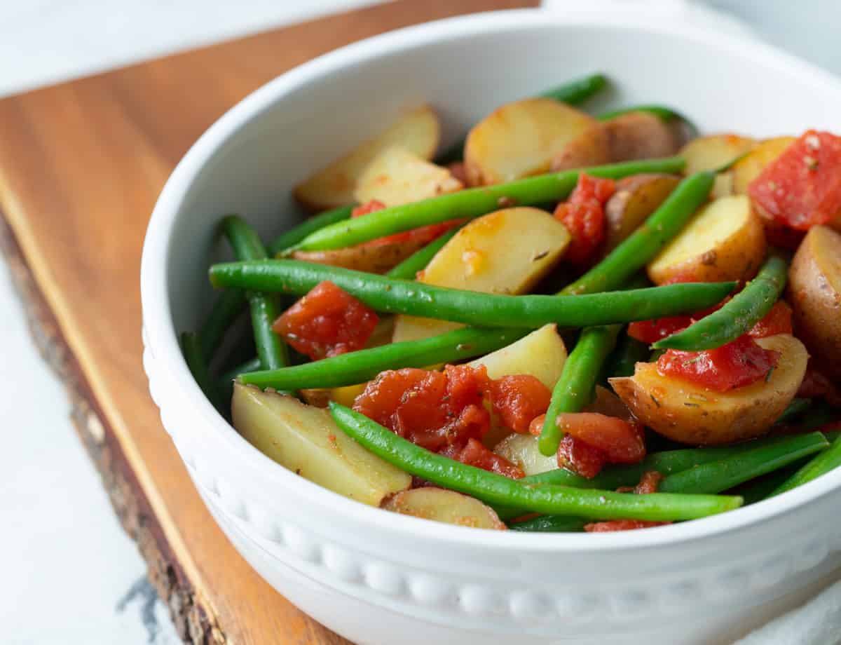 Vegetable side dish in white bowl.
