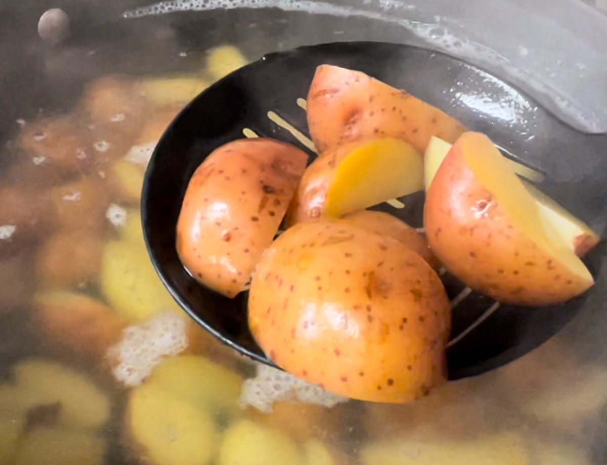 Draining red potatoes from boiling water.
