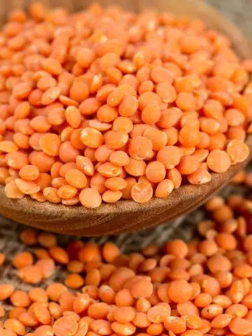 Red lentils in wood bowl.