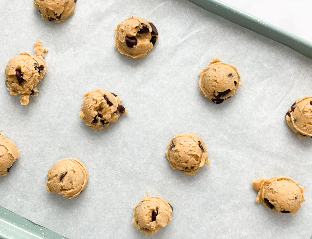 Cookie dough balls on baking sheet.
