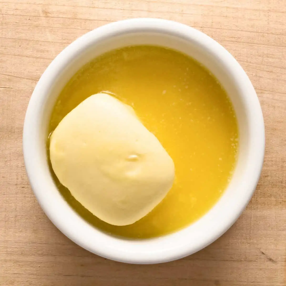 Melting butter in small white ramekin. 
