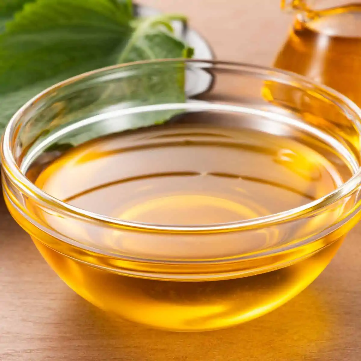 Vegetable oil in small glass bowl.

